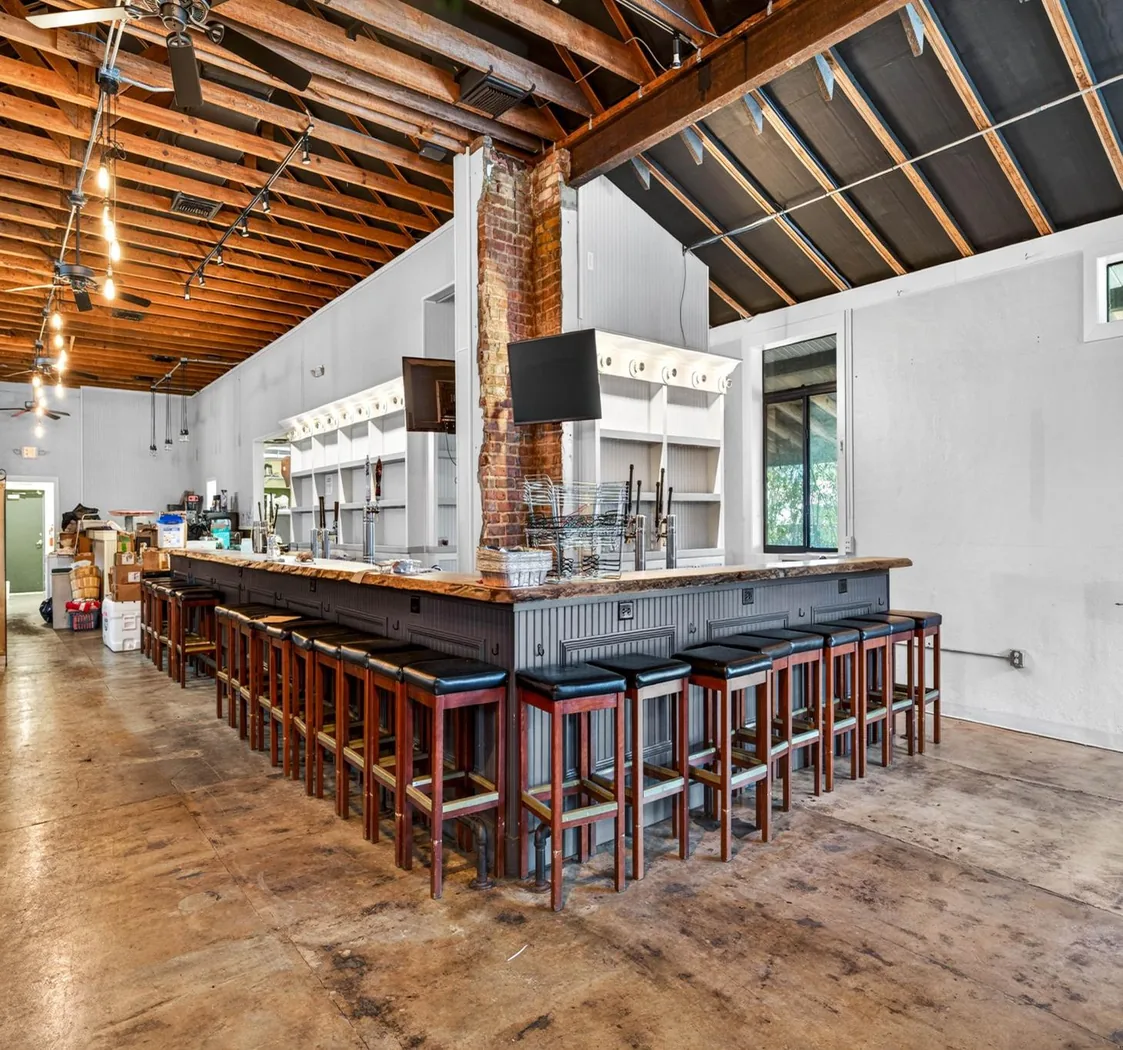 Existing timber ceiling, exposed brick and substantial bar inside the vacant restaurant space